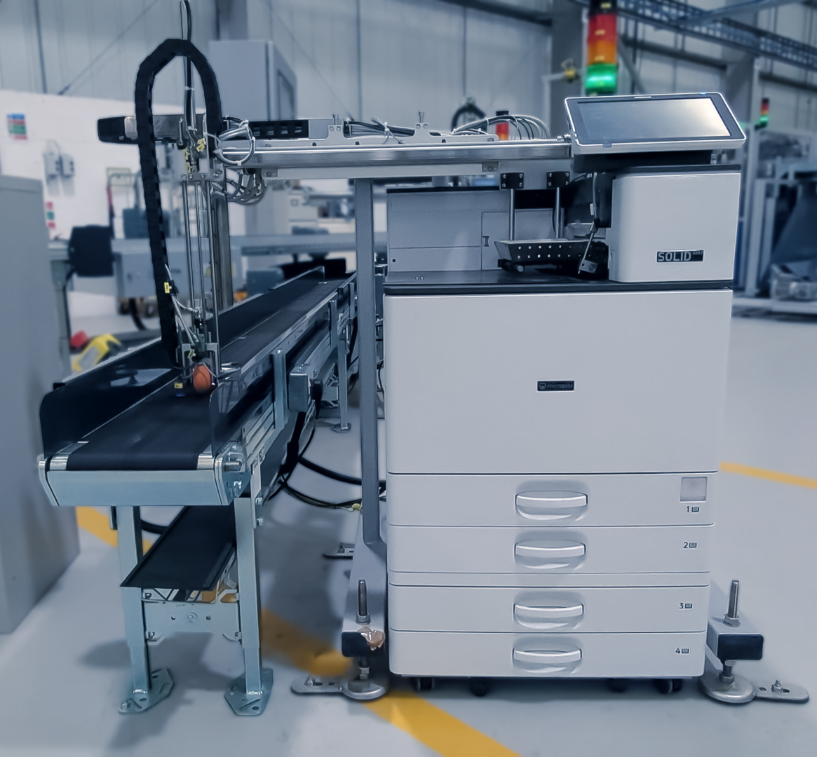 Microplex SOLID printer with integrated conveyor and applicator arm